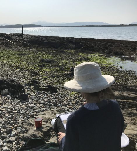 Image of Sue Barclay painting near a loch in Scotland