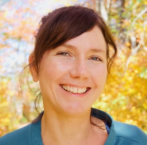 Photo of a smiling White woman with brown hair and blue eyes